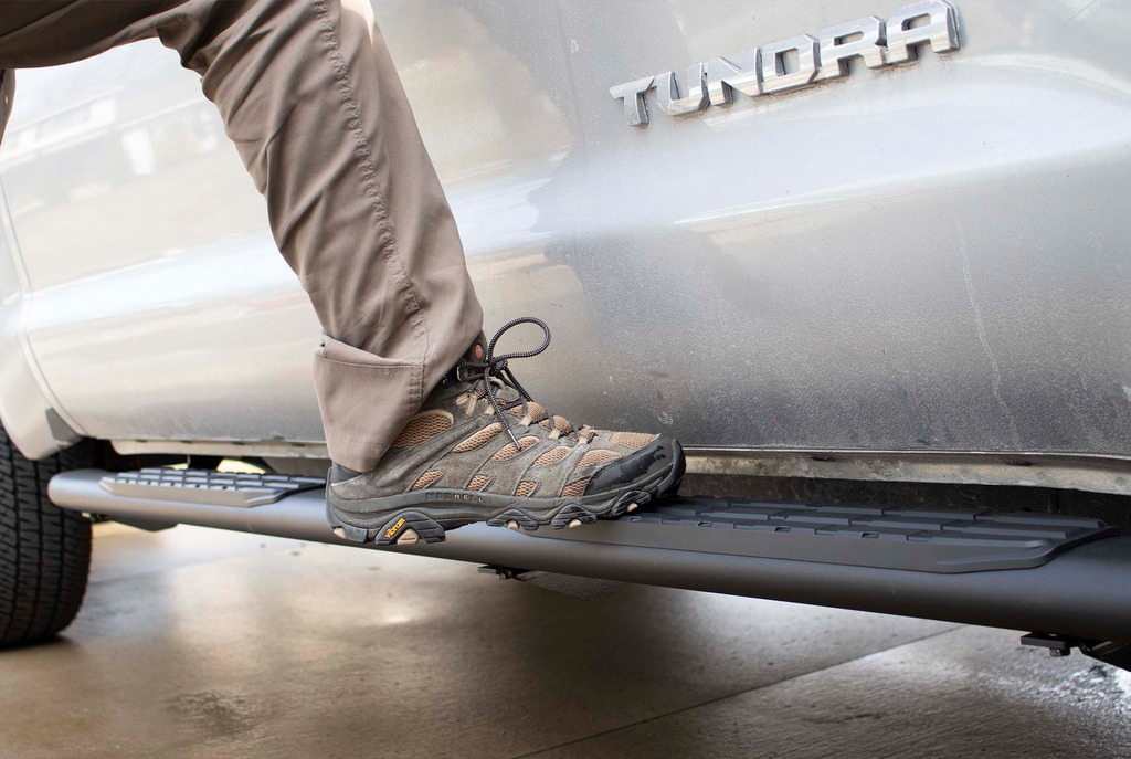 Robust 5-inch oval side steps with a sleek black textured finish, meticulously crafted for the Toyota Tundra Crew Max Cab, showcasing the unmistakable Fishbone grip step pad.