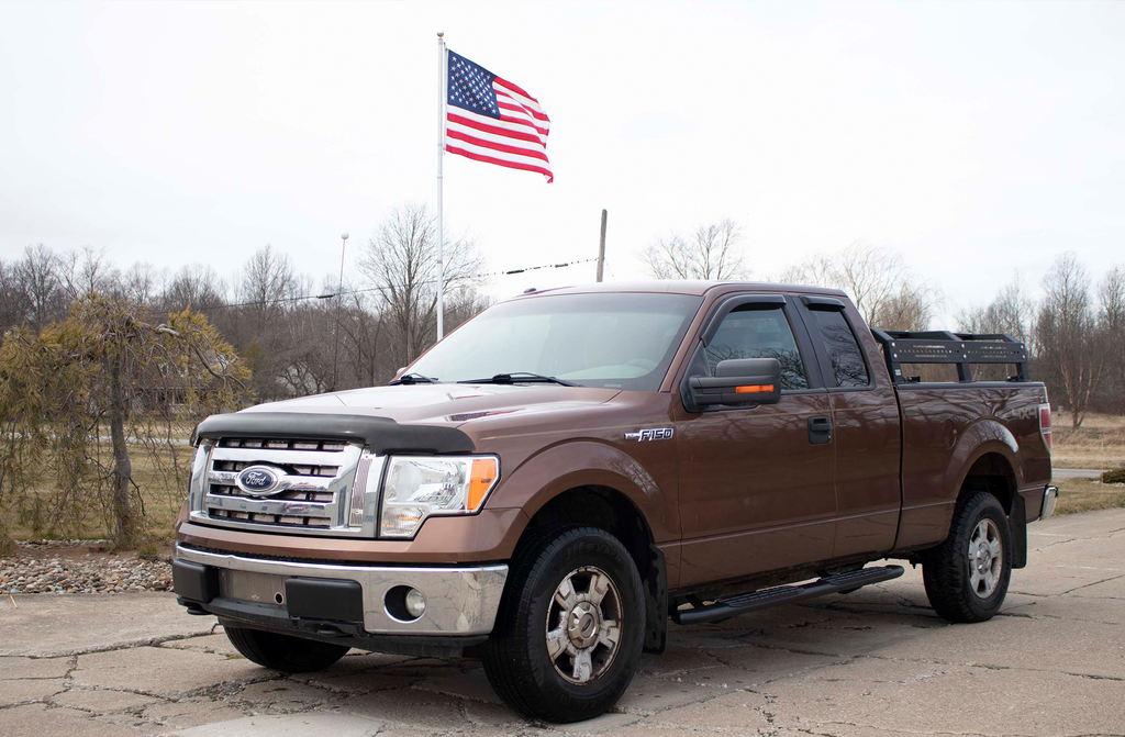 brown Ford F-150 Super Cab with Fishbone 5-inch oval steps