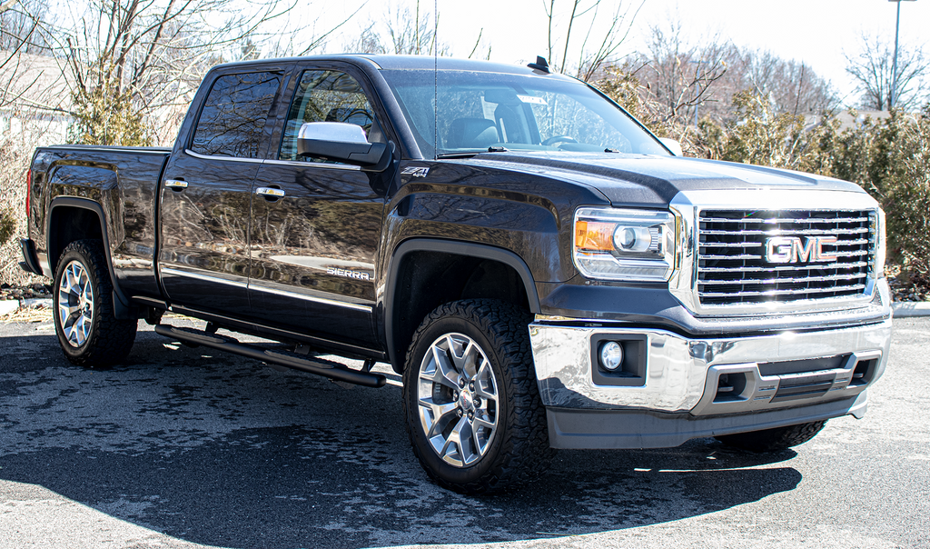 Robust 5-inch oval side steps with a distinct black textured finish, tailored for Chevrolet & GMC crew cab pickups, featuring a molded Fishbone grip step pad.