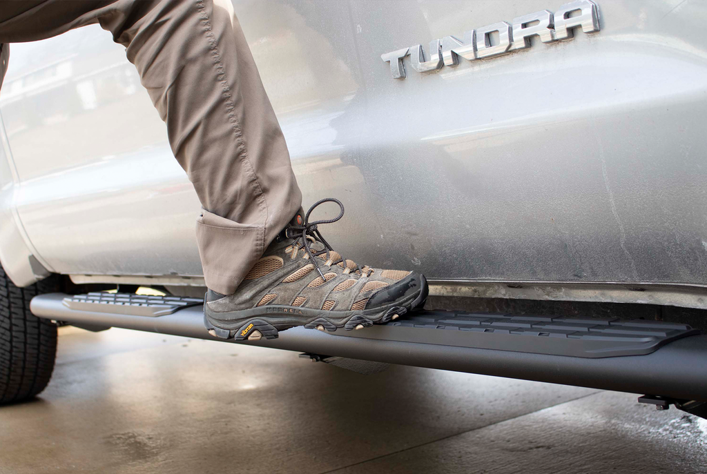 Robust 5-inch oval side steps with a sleek black textured finish, meticulously crafted for the Toyota Tundra Double Cab, showcasing the unmistakable Fishbone grip step pad.