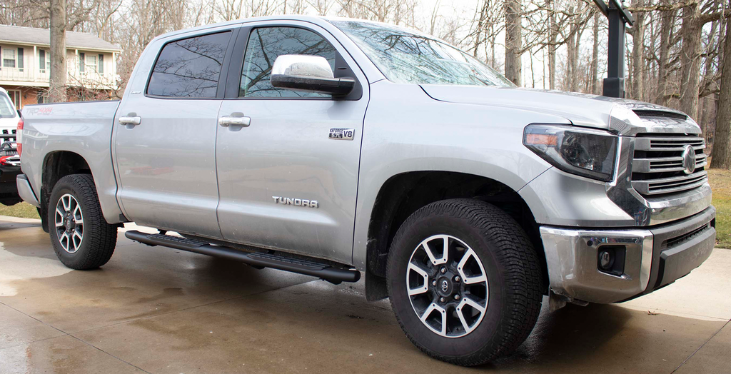 Robust 5-inch oval side steps with a sleek black textured finish, meticulously crafted for the Toyota Tundra Double Cab, showcasing the unmistakable Fishbone grip step pad.
