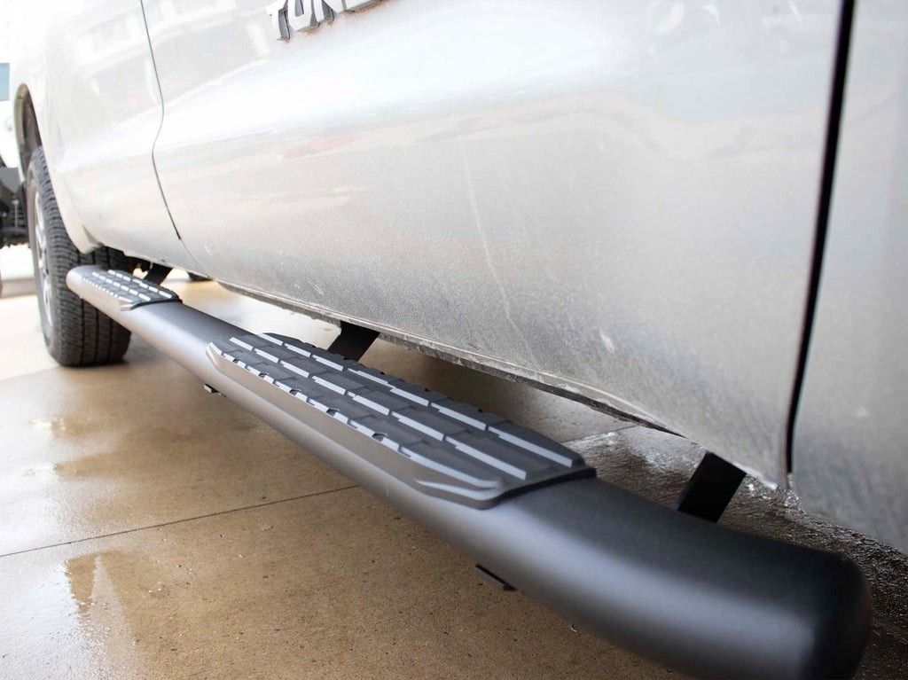 Robust 5-inch oval side steps with a sleek black textured finish ...