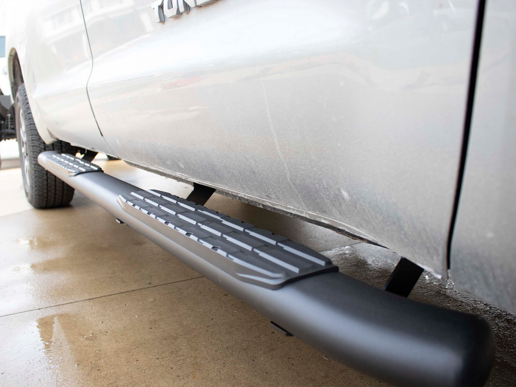 Robust 5-inch oval side steps with a sleek black textured finish, meticulously crafted for the Toyota Tundra Double Cab, showcasing the unmistakable Fishbone grip step pad.