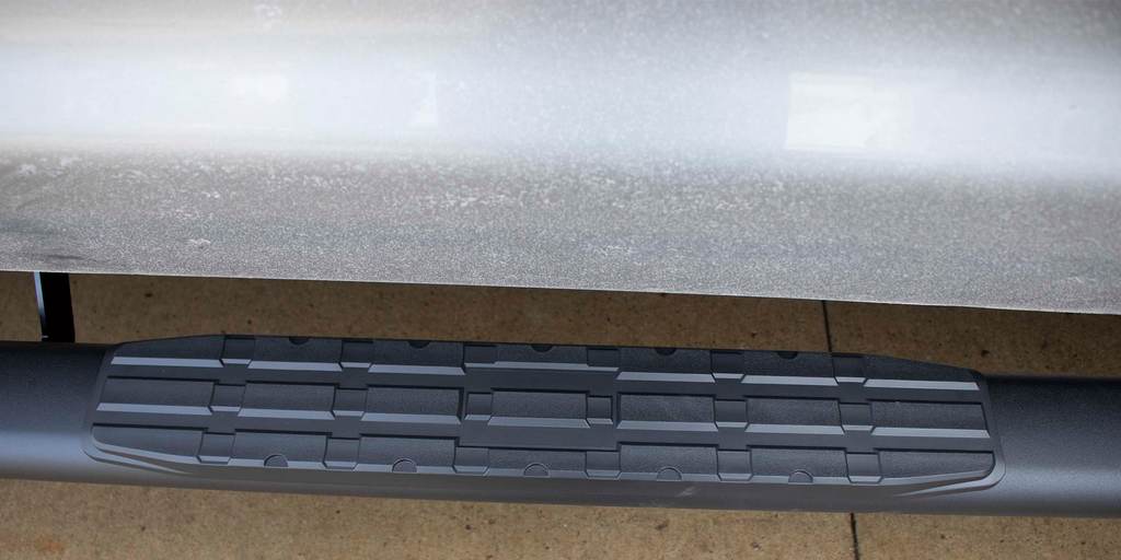 Robust 5-inch oval side steps with a sleek black textured finish, meticulously crafted for the Toyota Tundra Crew Max Cab, showcasing the unmistakable Fishbone grip step pad.