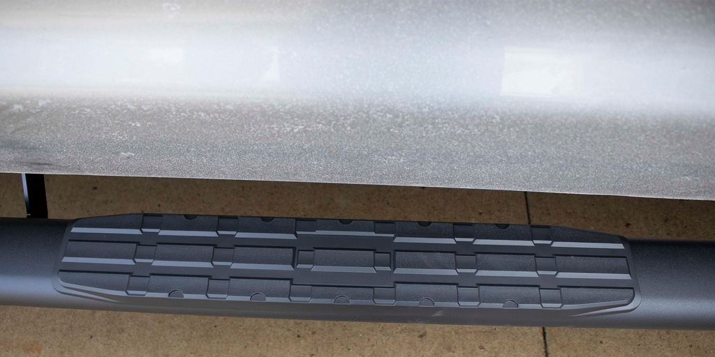 Robust 5-inch oval side steps with a sleek black textured finish, meticulously crafted for the Toyota Tundra Double Cab, showcasing the unmistakable Fishbone grip step pad.