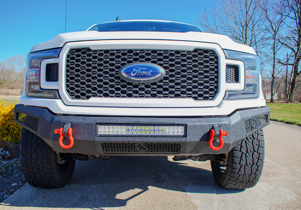 Robust black textured Fishbone Offroad Pelican Front Bumper mounted on a 2018-2020 Ford F-150, showcasing LED light mounts, front skid plate, and D-ring mounts for enhanced protection and style.
