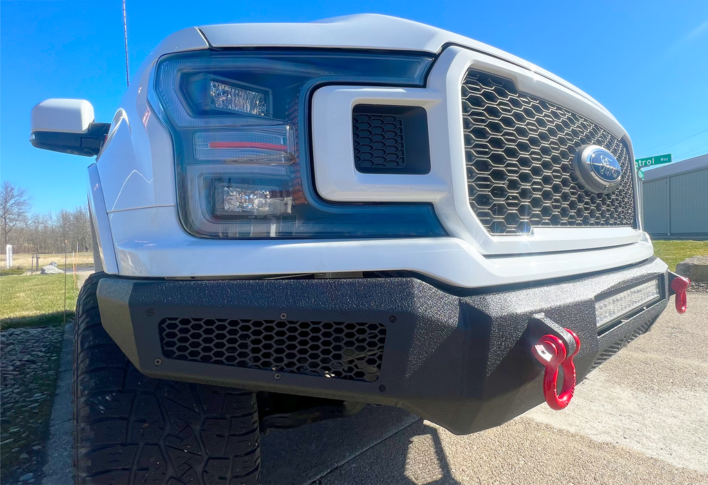 Robust black textured Fishbone Offroad Pelican Front Bumper mounted on a 2018-2020 Ford F-150, showcasing LED light mounts, front skid plate, and D-ring mounts for enhanced protection and style.