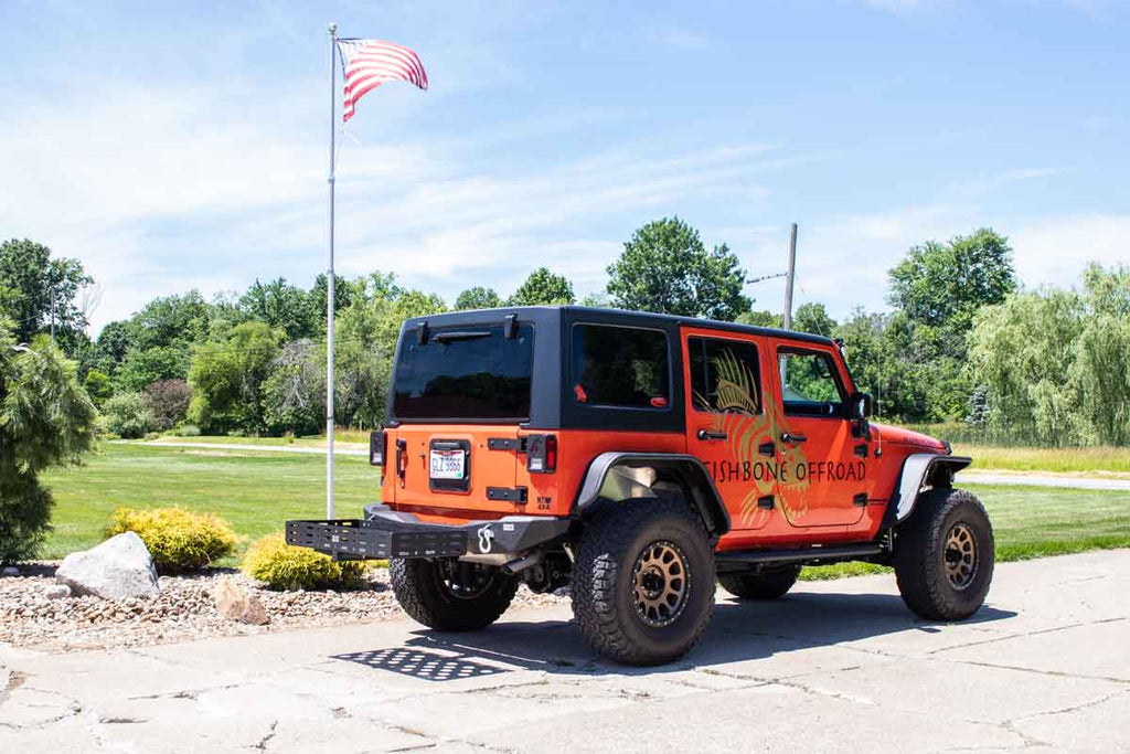 Fishbone Offroad Cargo Basket attached to a vehicle, demonstrating its sturdy construction and fit for a 2" hitch receiver.