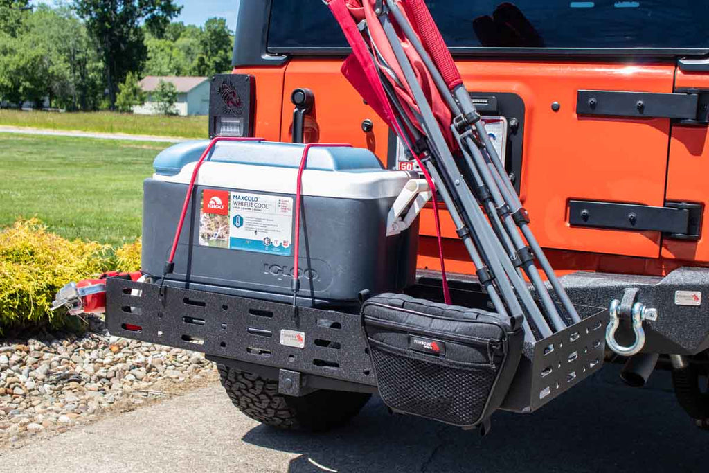 Fishbone Offroad Cargo Basket attached to a vehicle, demonstrating its sturdy construction and fit for a 2" hitch receiver.