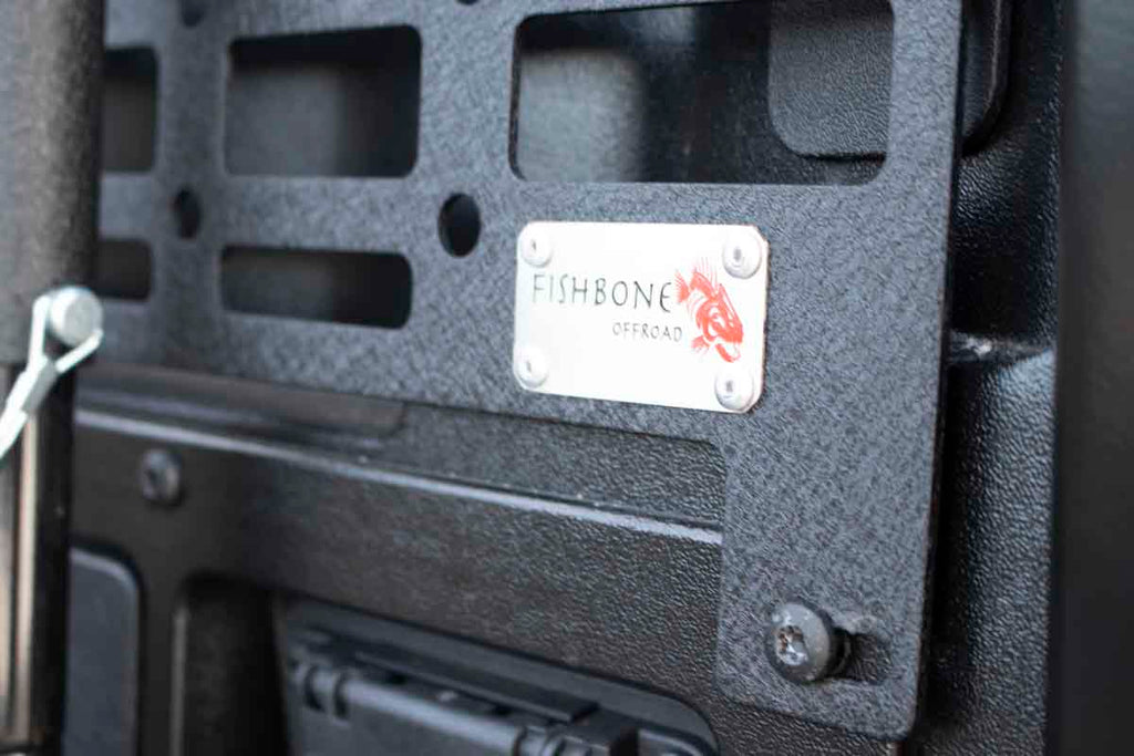 Close up image of Fishbone logo on Black MOLLE Panels for Toyota Tacoma - Short Bed  