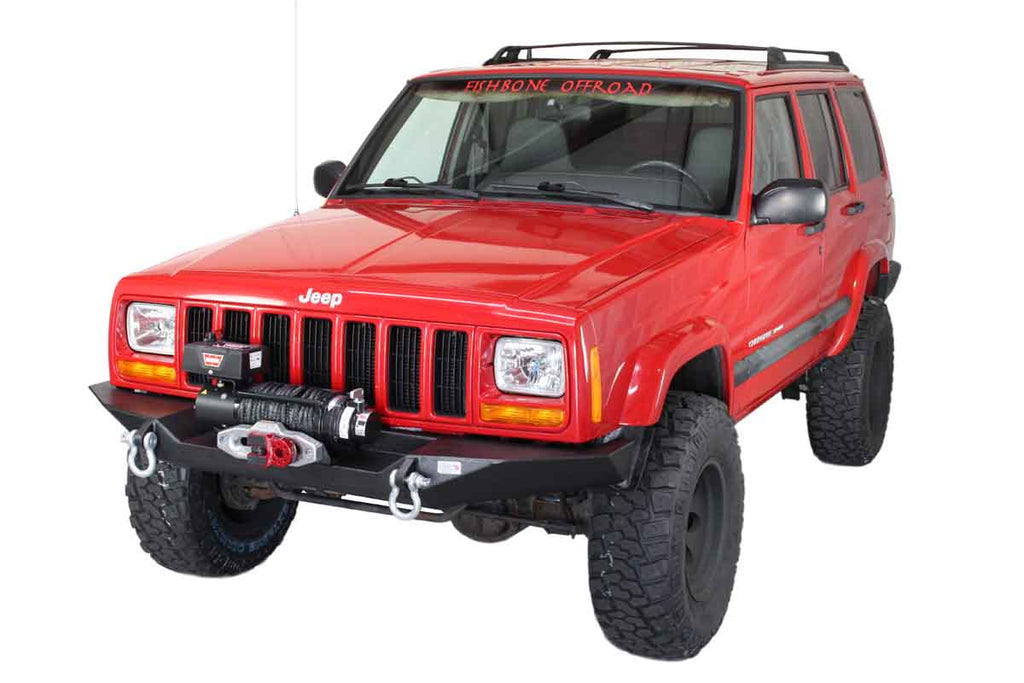 Jeep Cherokee XJ equipped with the Fishbone Offroad Bullhead Front Bumper, highlighting the bumper's sleek design and functionality in an off-road setting