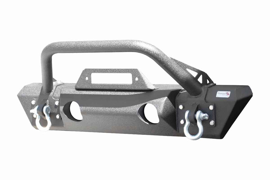 Fishbone Offroad Front Stubby Winch Bumper, perfectly contoured under a Jeep grill, showcasing durability and rugged elegance.