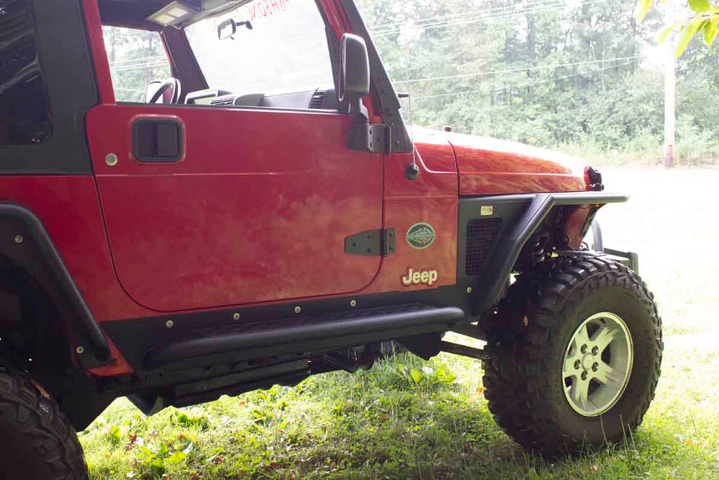 Fishbone Offroad Rock Sliders with a Tube Side Step, expertly crafted for Jeep Wrangler TJ, showcasing robust protection and elegant design.