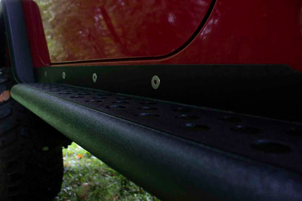 Fishbone Offroad Rock Sliders with a Tube Side Step, expertly crafted for Jeep Wrangler TJ, showcasing robust protection and elegant design.