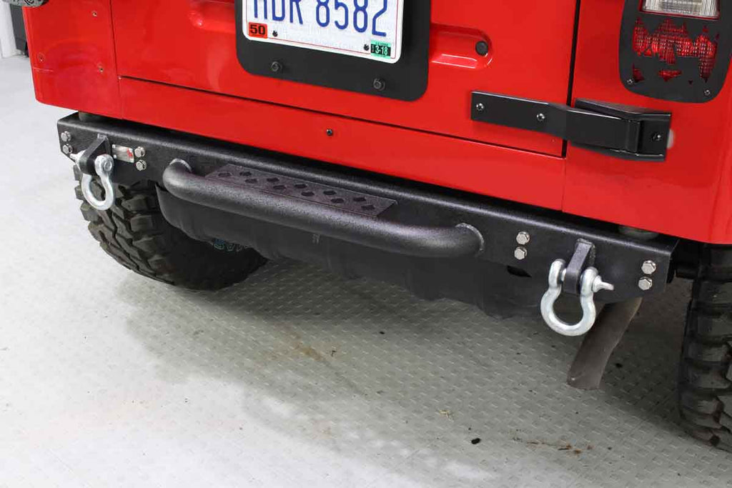 Fishbone Offroad Piranha Rear Bumper installed on a Jeep Wrangler, showcasing the built-in Tube Step.